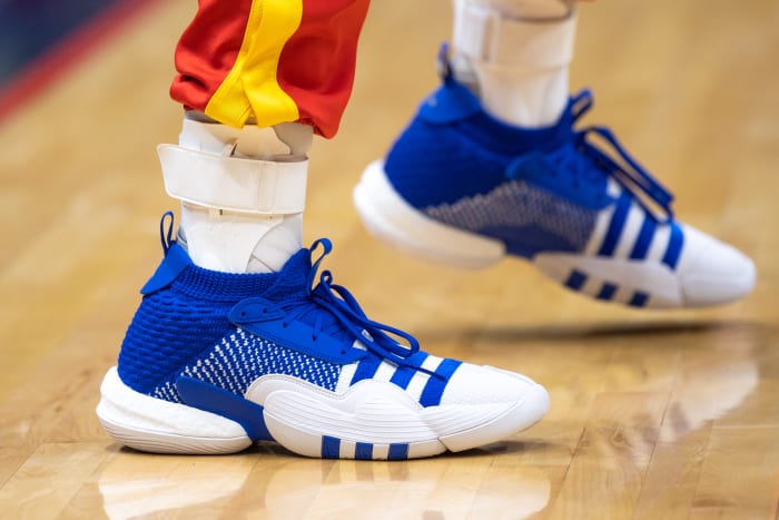 View of Trae Young's blue and white adidas shoes.